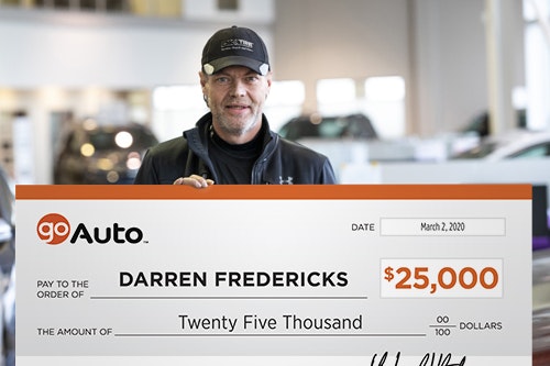 Photo of contest winner Darren Fredericks holding cheque