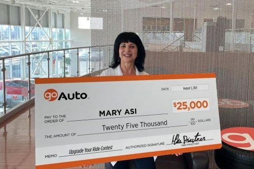 Photo of contest winner Mary Asi holding cheque